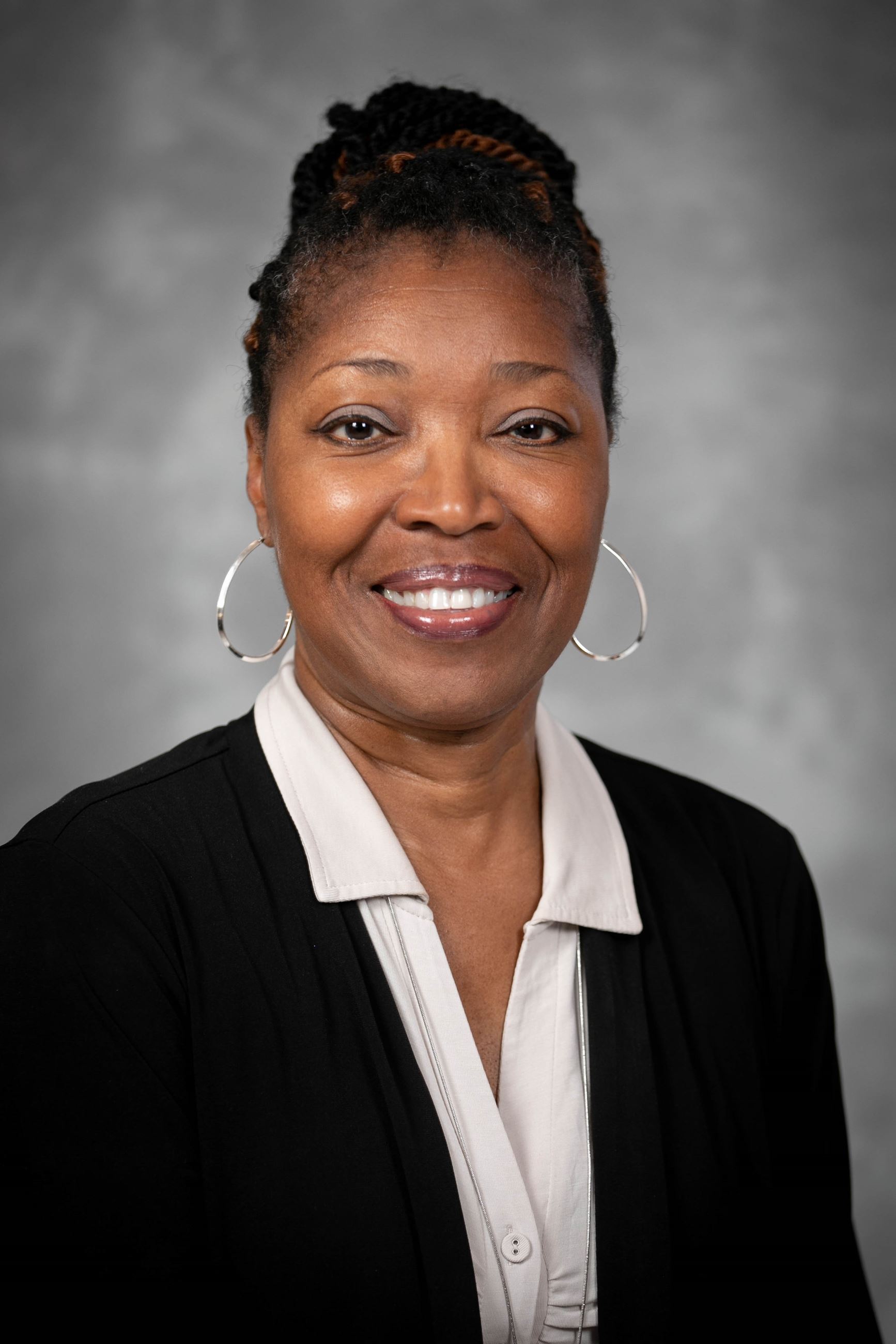 Headshot of a woman in a shirt and blazer.
