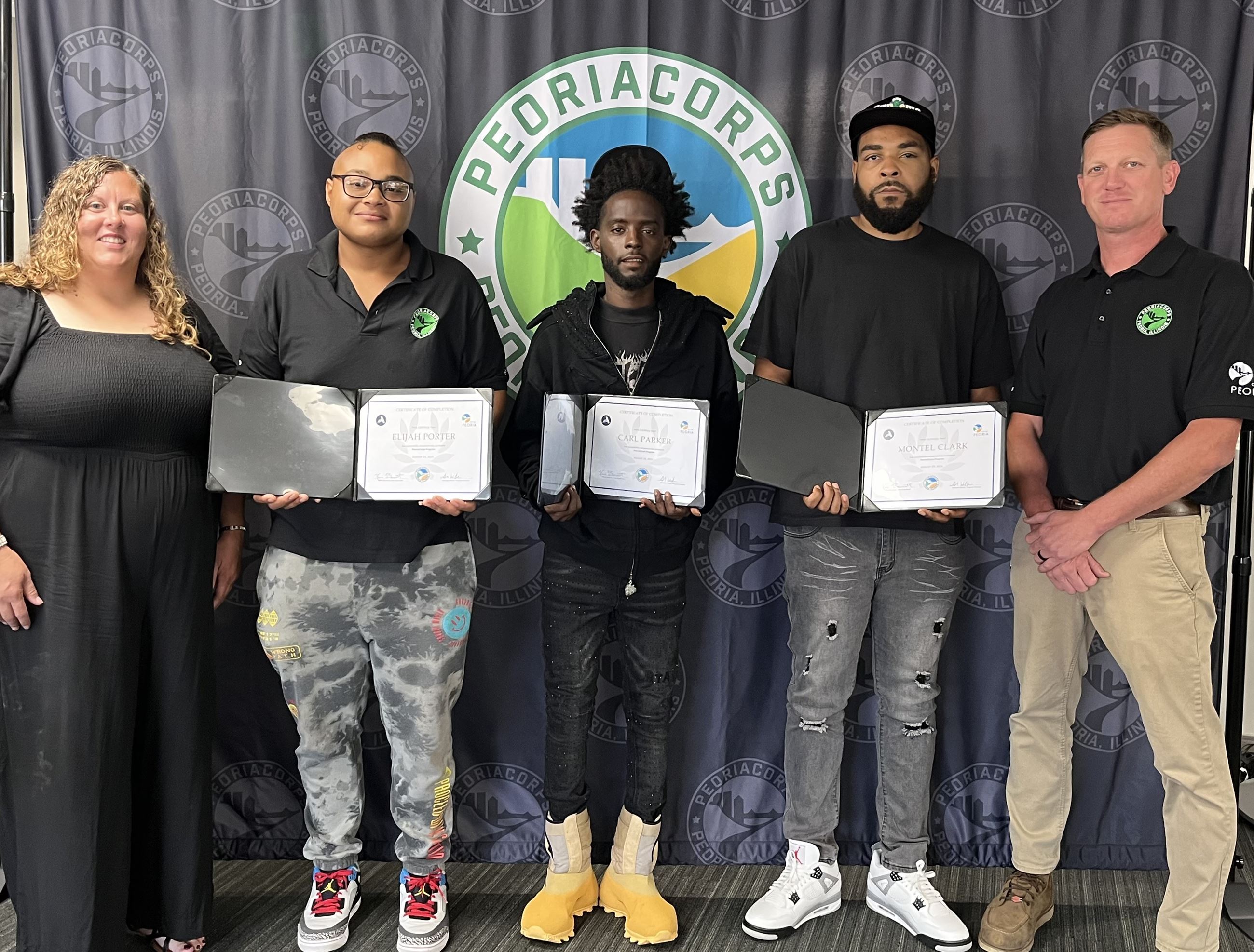 A group of people, pose together in front of a 